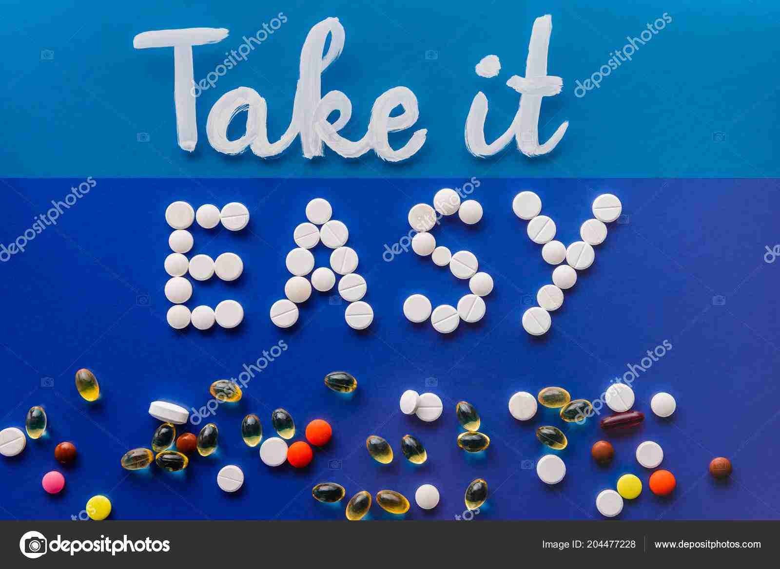 Take it easy" spelled out in white letters against a blue background, surrounded by an assortment of colorful pills and capsules scattered around the message. easiest company to get a contract phone with